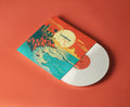 Vinyl record with colorful cover on a red background